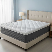 Mattress with quilted cover on a bed in a bedroom setting
